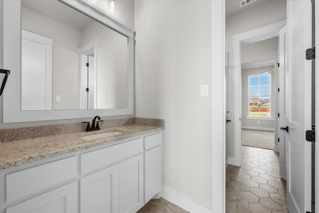 bathroom with tile patterned floors and vanity