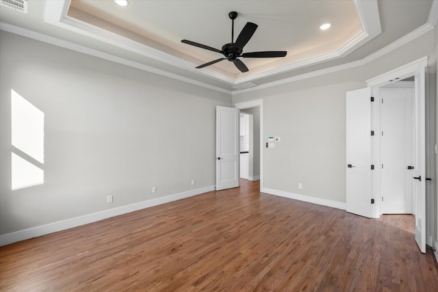 unfurnished bedroom with hardwood / wood-style floors, a raised ceiling, ornamental molding, and ceiling fan