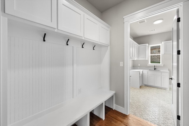 mudroom with hardwood / wood-style flooring and sink