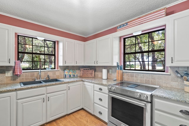 kitchen featuring sink, white cabinets, and stainless steel electric range oven