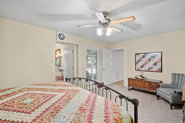 carpeted bedroom with a textured ceiling and ceiling fan