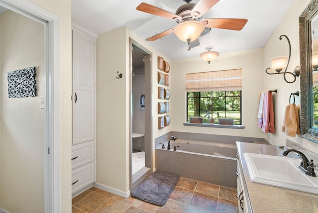 bathroom with vanity, ceiling fan, and a bathing tub