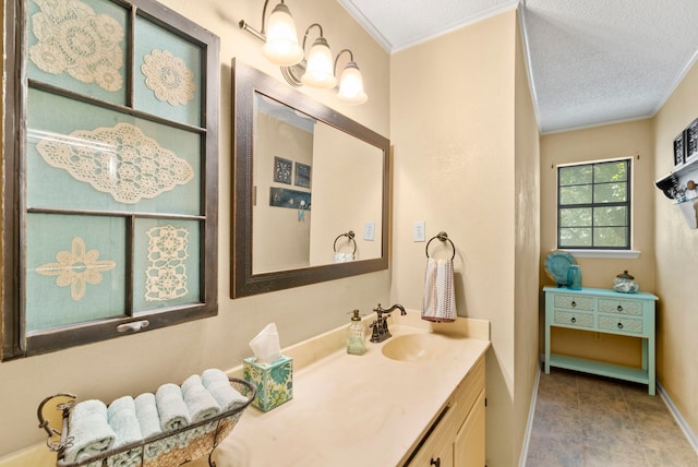 bathroom featuring vanity, a textured ceiling, and ornamental molding