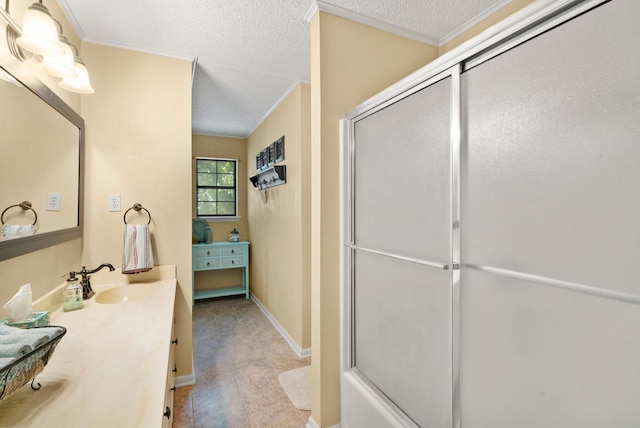 bathroom featuring vanity, a textured ceiling, and an enclosed shower