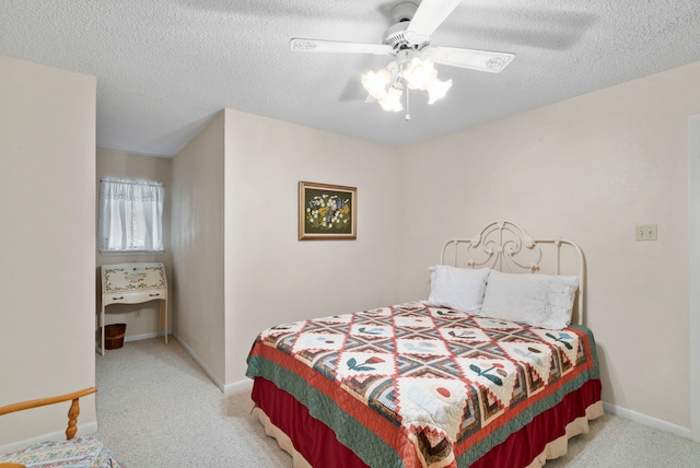 carpeted bedroom with a textured ceiling and ceiling fan