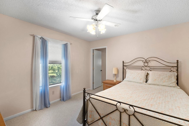 carpeted bedroom with a textured ceiling and ceiling fan