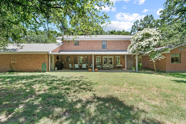 back of property featuring a patio area and a lawn