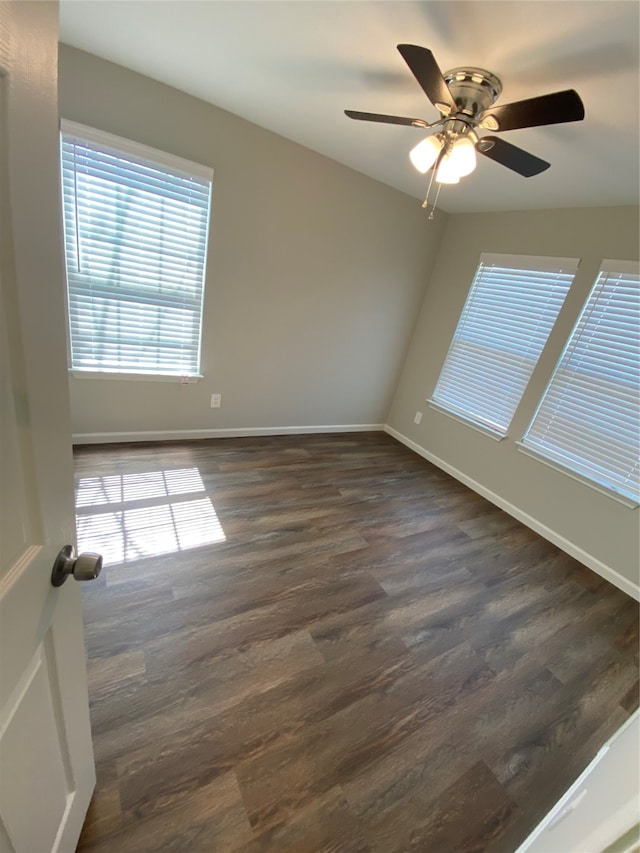 empty room with ceiling fan and dark wood-type flooring