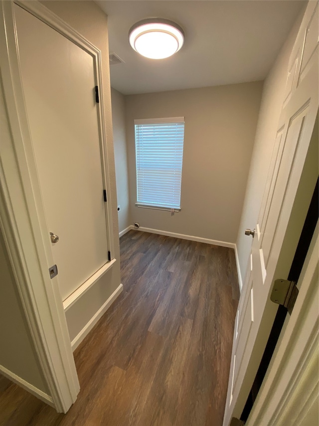 hallway with dark hardwood / wood-style flooring