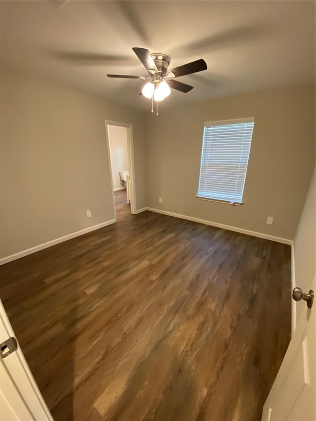 unfurnished bedroom featuring ceiling fan and dark wood-type flooring