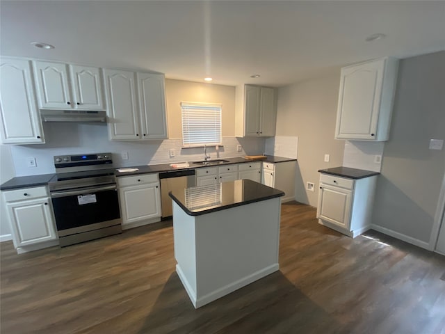 kitchen with sink, white cabinetry, stainless steel appliances, and dark wood-type flooring