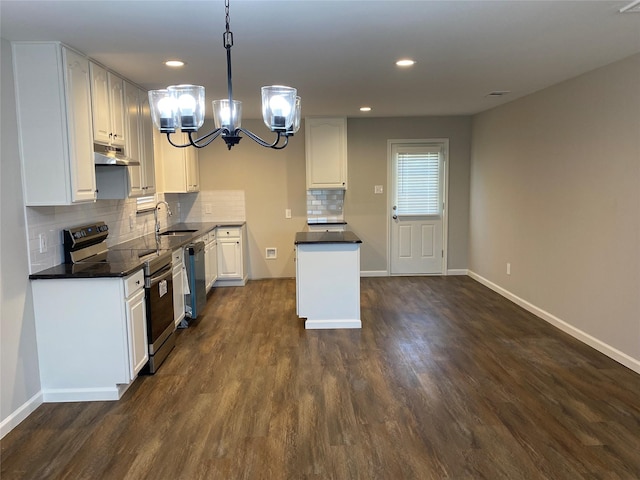 kitchen featuring stainless steel appliances, sink, pendant lighting, dark hardwood / wood-style floors, and white cabinetry