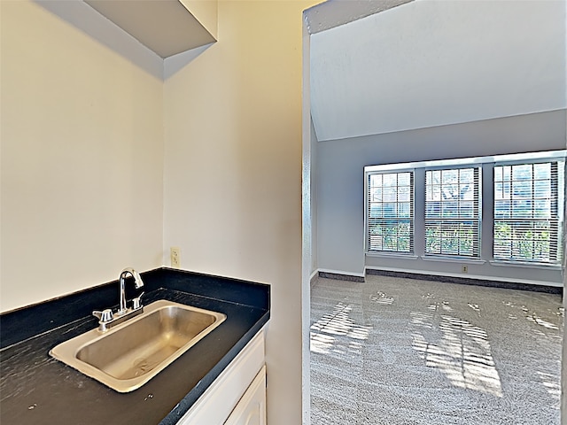 interior space featuring vaulted ceiling and vanity