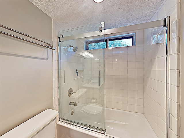 full bath with toilet, enclosed tub / shower combo, and a textured ceiling