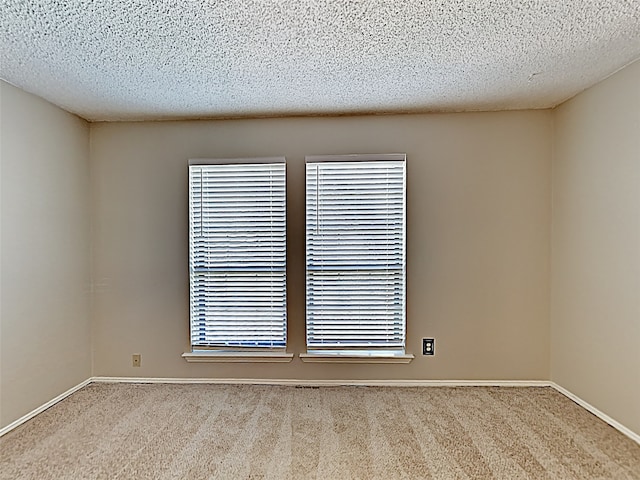 unfurnished room featuring carpet floors and a textured ceiling