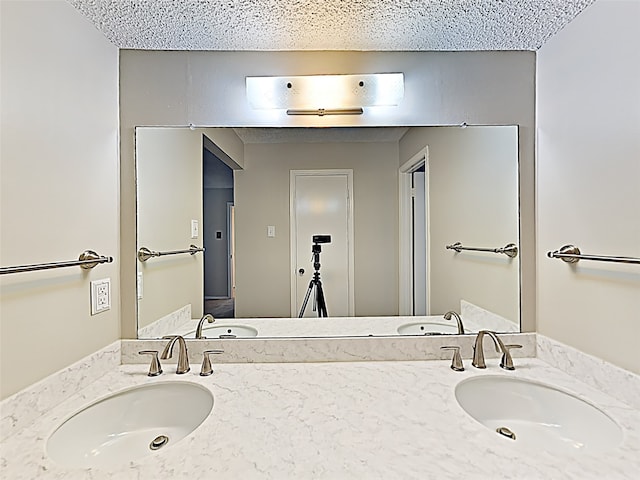 bathroom with a sink and double vanity