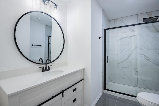 bathroom with a shower with door, toilet, vanity, and tile patterned flooring