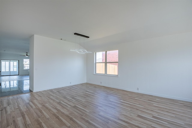 spare room featuring light wood-type flooring and ceiling fan