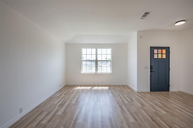 entrance foyer with lofted ceiling and light hardwood / wood-style flooring