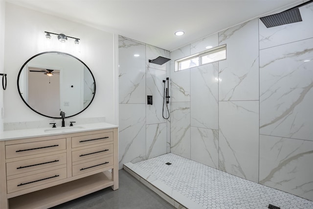 bathroom featuring ceiling fan, tile patterned floors, vanity, and a tile shower