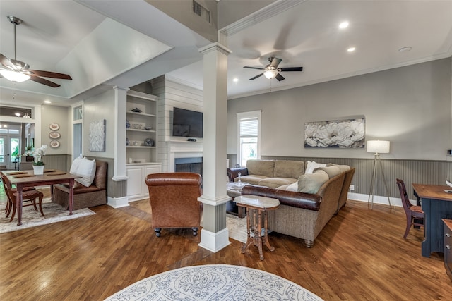 living room featuring a large fireplace, ceiling fan, and dark hardwood / wood-style flooring