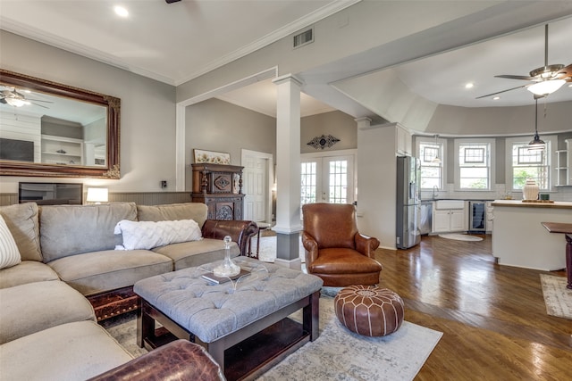 living room featuring crown molding, ceiling fan, wine cooler, and dark hardwood / wood-style floors