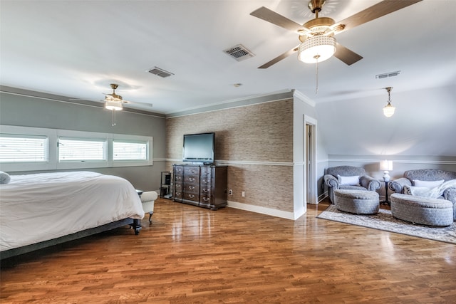 bedroom with crown molding, wood-type flooring, and ceiling fan