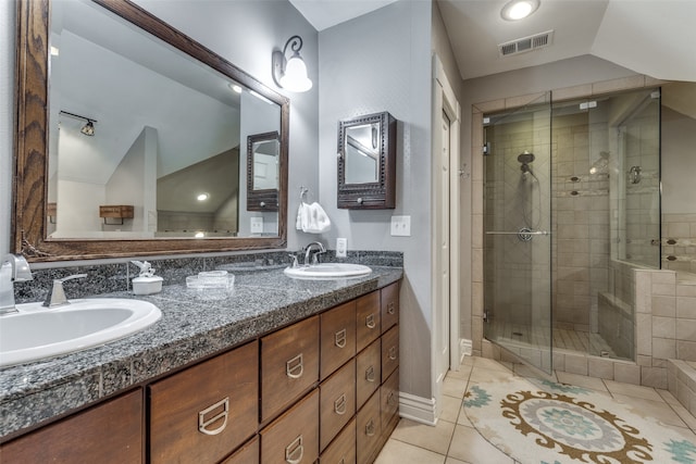 bathroom featuring tile patterned flooring, vaulted ceiling, an enclosed shower, and vanity