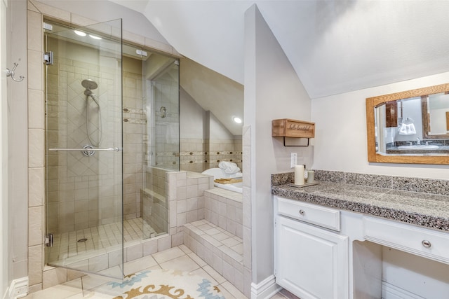 bathroom with vanity, lofted ceiling, an enclosed shower, and tile patterned floors