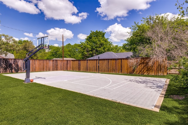 view of sport court with a yard