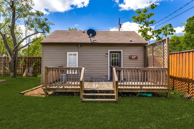 rear view of house featuring a yard and a deck