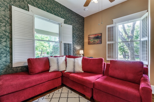 living room with a wealth of natural light, light hardwood / wood-style flooring, and ceiling fan