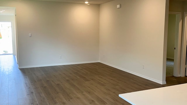 unfurnished room with dark hardwood / wood-style floors