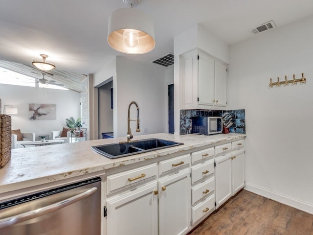 kitchen featuring white cabinets, ceiling fan, appliances with stainless steel finishes, wood-type flooring, and sink