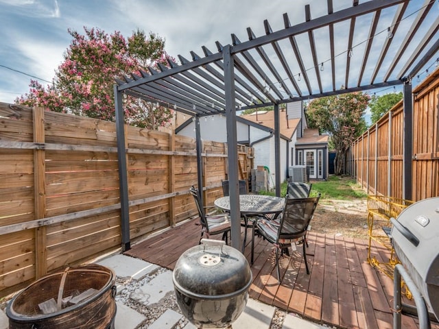 wooden terrace with a pergola, grilling area, an outdoor fire pit, and a shed