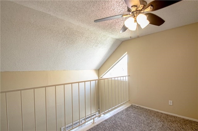 additional living space featuring a textured ceiling, carpet floors, lofted ceiling, and ceiling fan