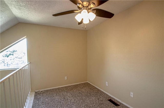 interior space featuring lofted ceiling, a textured ceiling, and ceiling fan