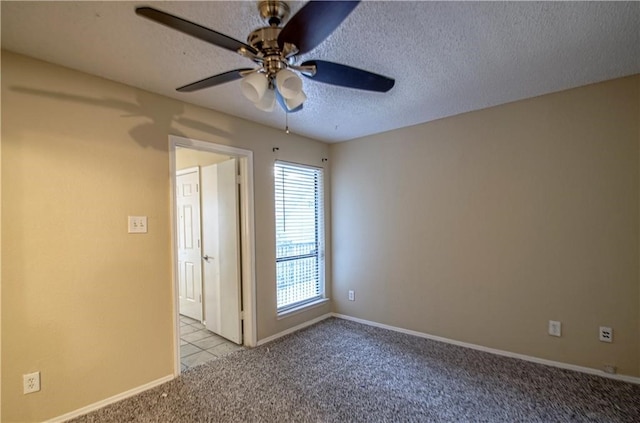 carpeted empty room with a textured ceiling and ceiling fan