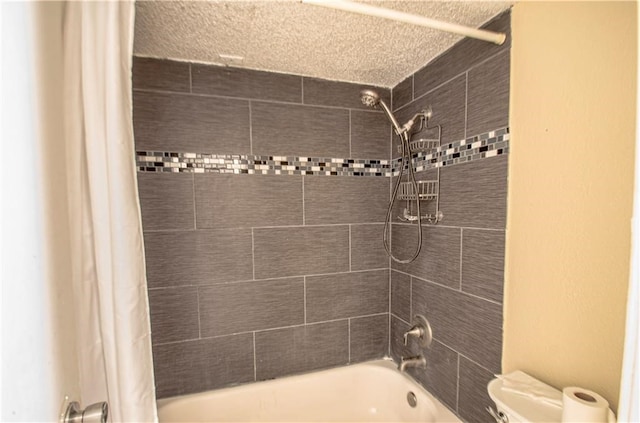 bathroom with a textured ceiling, toilet, and shower / bathtub combination with curtain