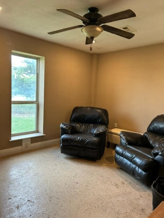 sitting room featuring ceiling fan and a wealth of natural light