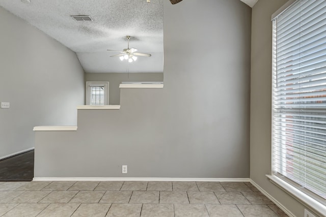 empty room featuring a textured ceiling and ceiling fan