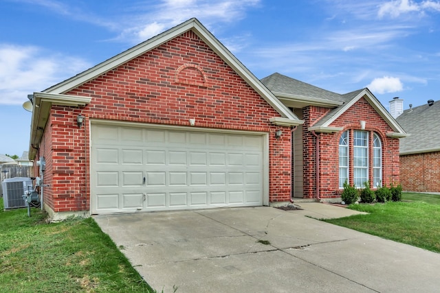 front facade featuring a front yard, a garage, and central AC unit