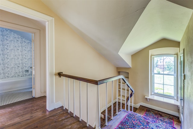 staircase with dark hardwood / wood-style floors and lofted ceiling