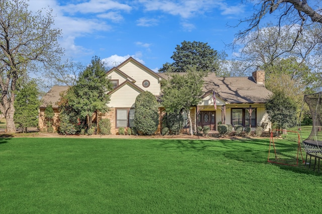 view of front of home featuring a trampoline and a front lawn