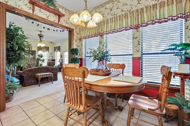 dining area featuring ceiling fan with notable chandelier and light tile patterned floors