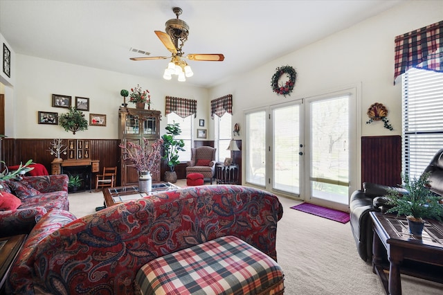 living room featuring a wealth of natural light, light colored carpet, and ceiling fan