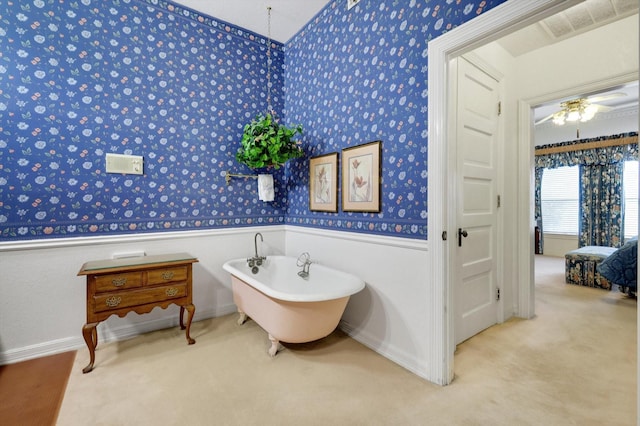 2201 Oak Knoll Ct, Colleyville, TX 76034 - bathroom with wallpapered walls, a wainscoted wall, a freestanding bath, and ceiling fan