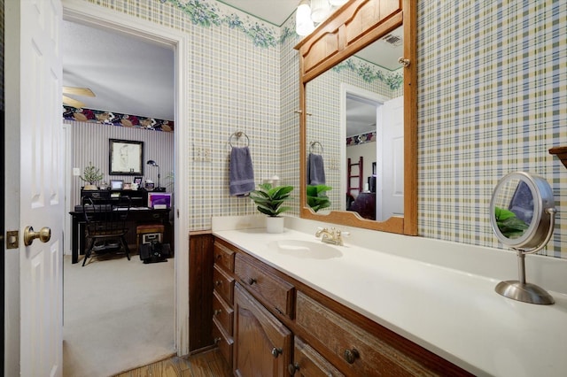 2201 Oak Knoll Ct, Colleyville, TX 76034 - bathroom featuring wallpapered walls, vanity, and wood finished floors