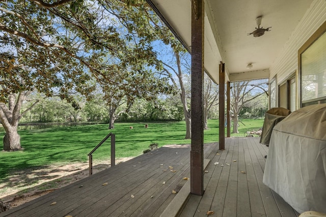 wooden deck with a lawn