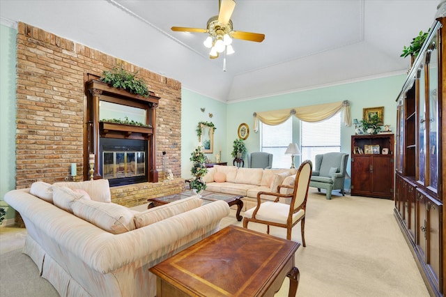 carpeted living room with a fireplace, vaulted ceiling, ornamental molding, and ceiling fan